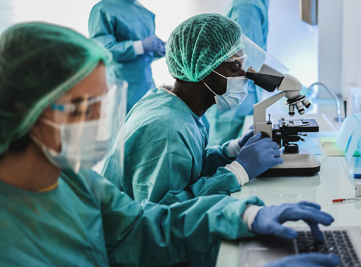 People in lab coat analysing a sample.