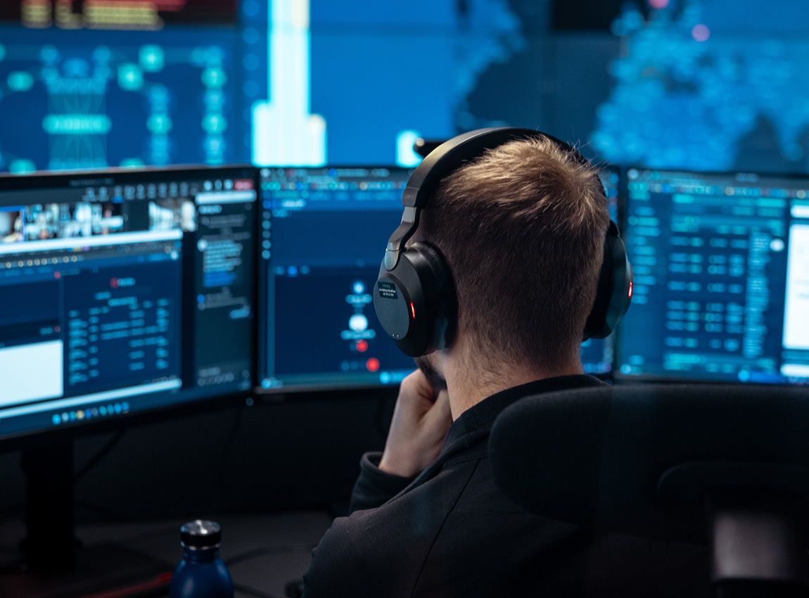 Man with headphones working on security incidents.